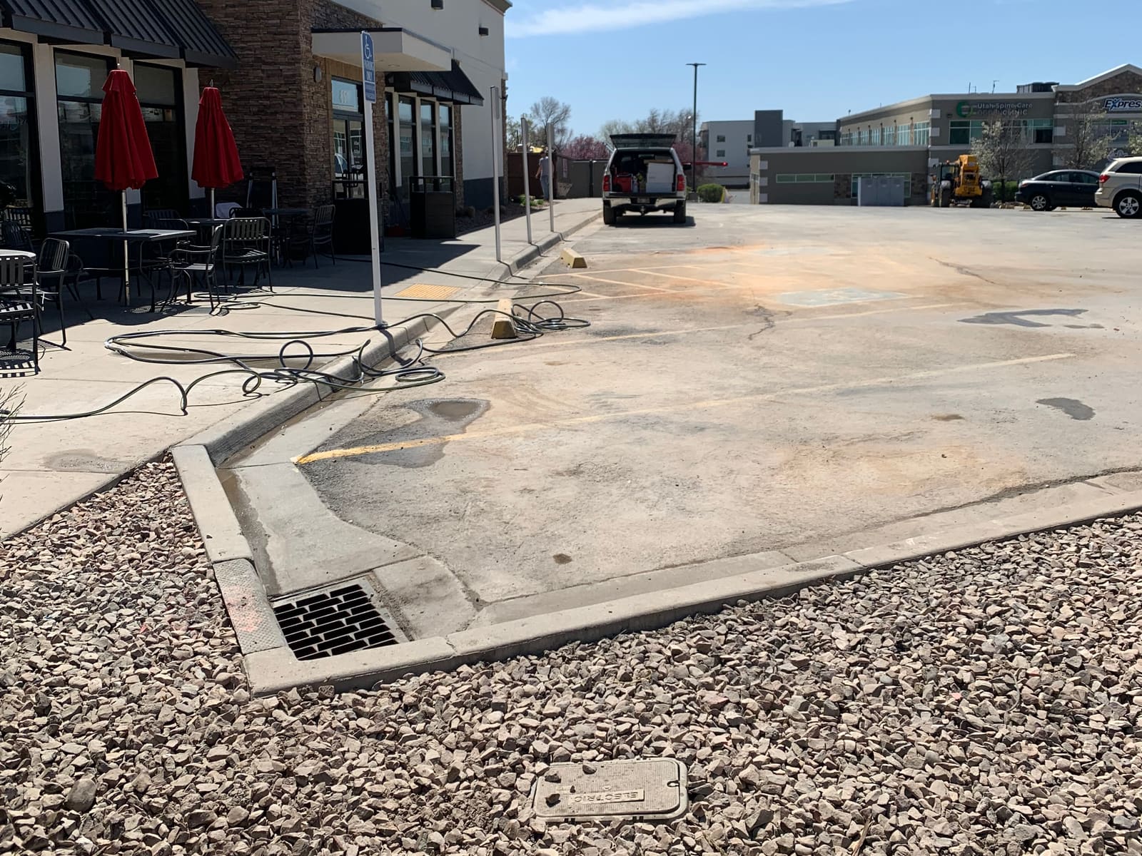 Restaurant drive-thru and patio before cleaning: stained concrete
